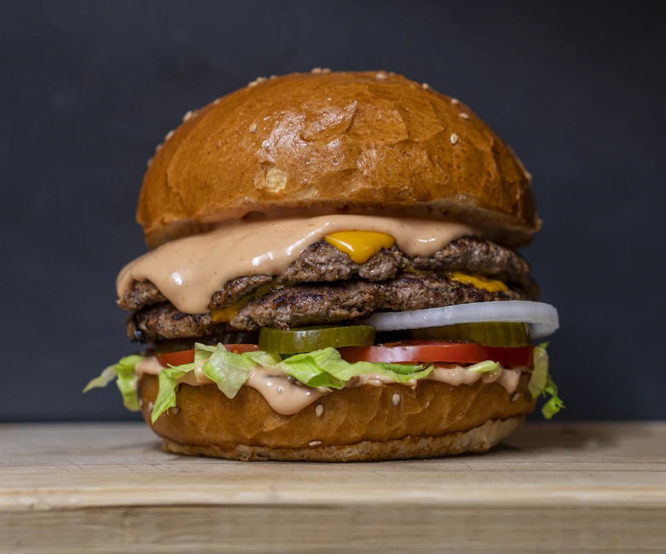 Hamburguesa con queso, verduras y salsa